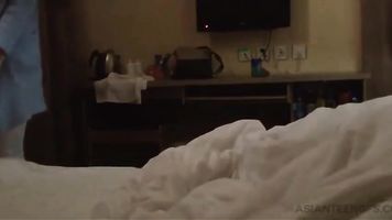 Cute Asian teen girl is sucking cock in a hotel (amateur)